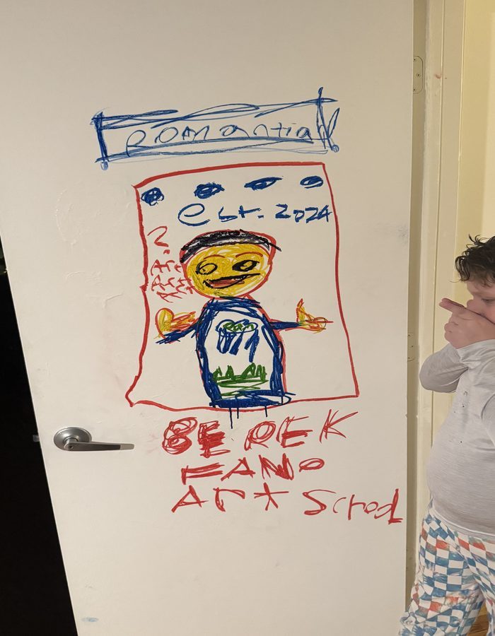 Stefano standing next to the door he drew on, labelled Berek Fano Art School